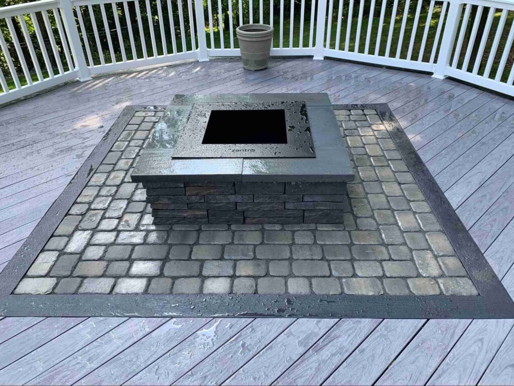 Stonedeks system enables mixed materials such as this stone fireplace in the middle of a composite board deck