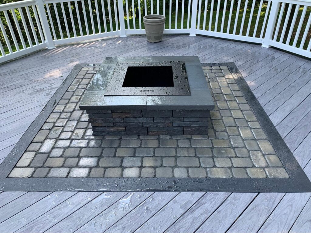 paver stones and composite materials working together to create a built-in deck and fire pit.