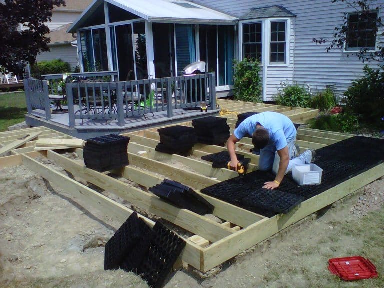 Photo of deck builder installing SilcaGrates as part of a deck transformation using the Silca System.