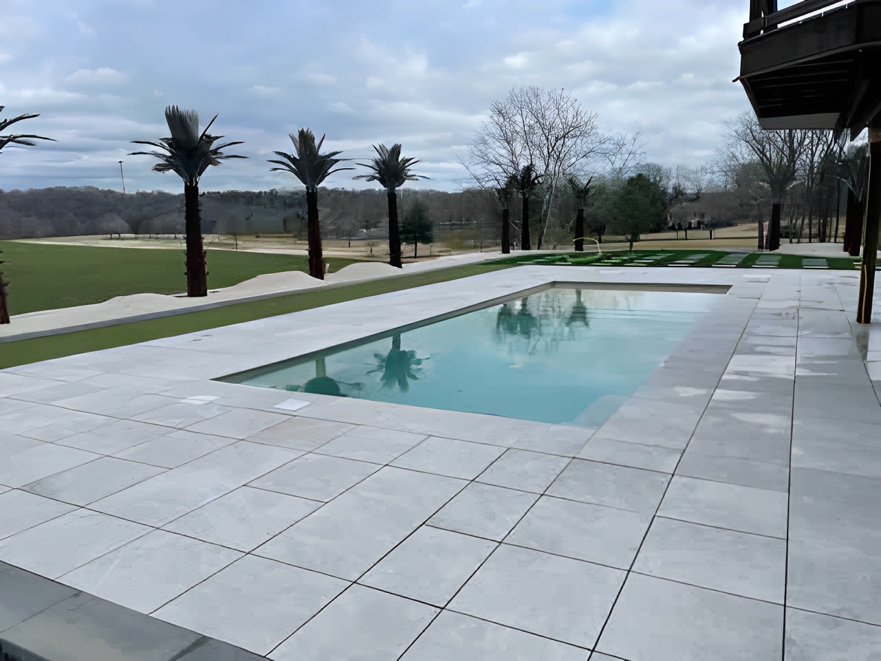 Paver Pool Decks - https://stonedeks.com/wp-content/uploads/2025/01/Porcelain-Paver-Pool-Deck-StoneDek-upscaled.jpg