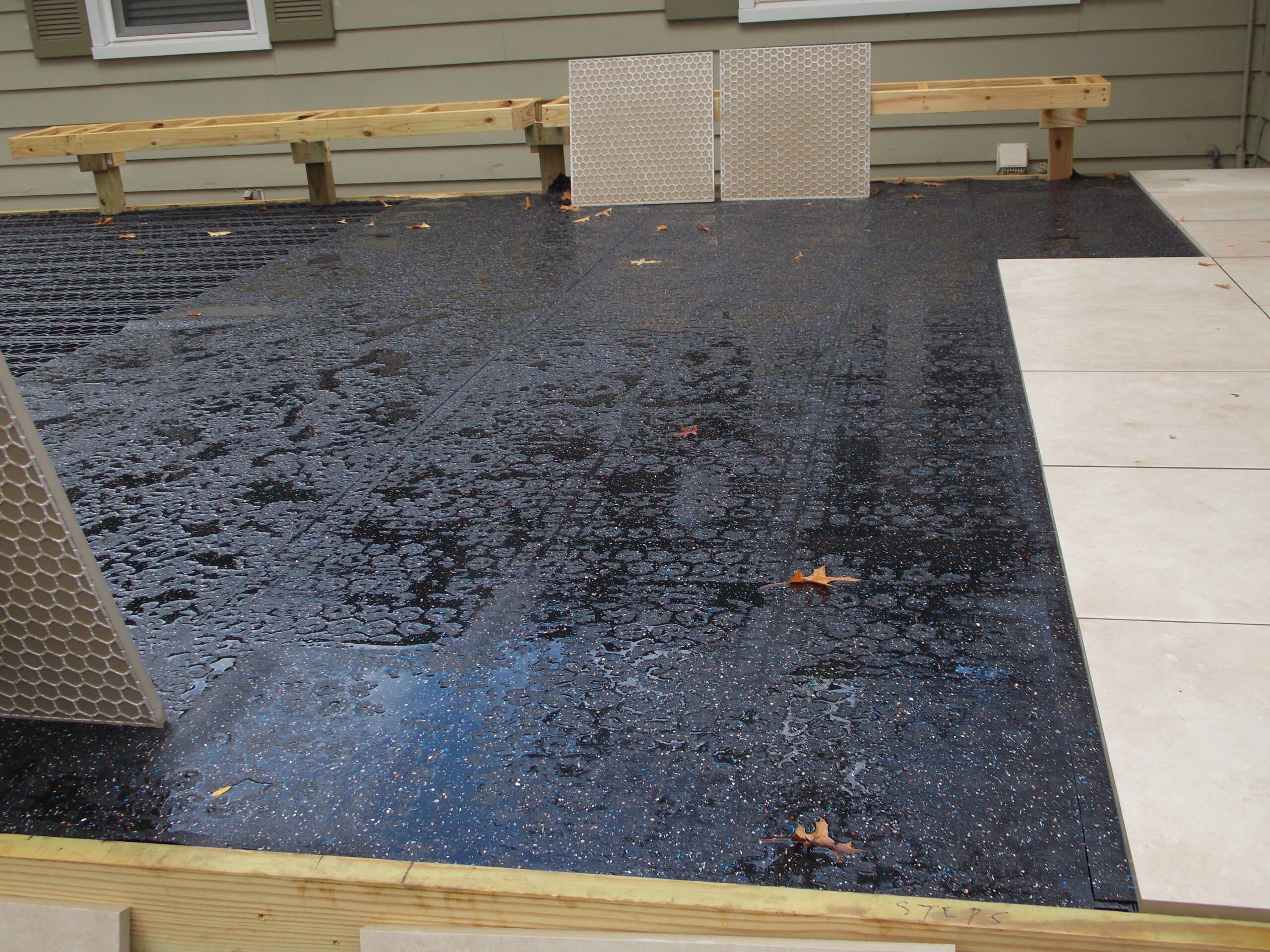 Silcamat installation over Silcagrate for porcelain pavers on deck